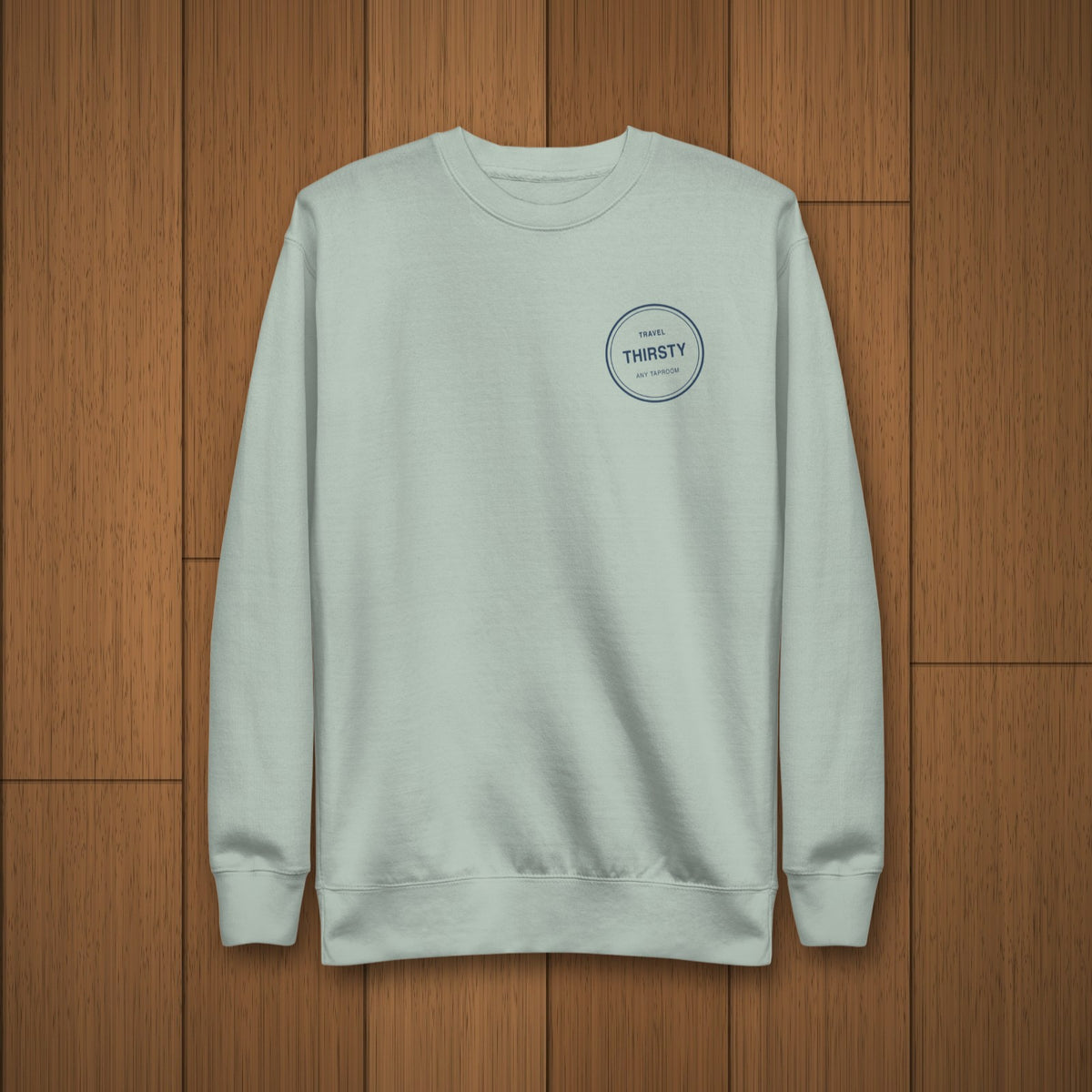 Brewery Passport Crewneck Sweatshirt in Agave laid flat on oak boards