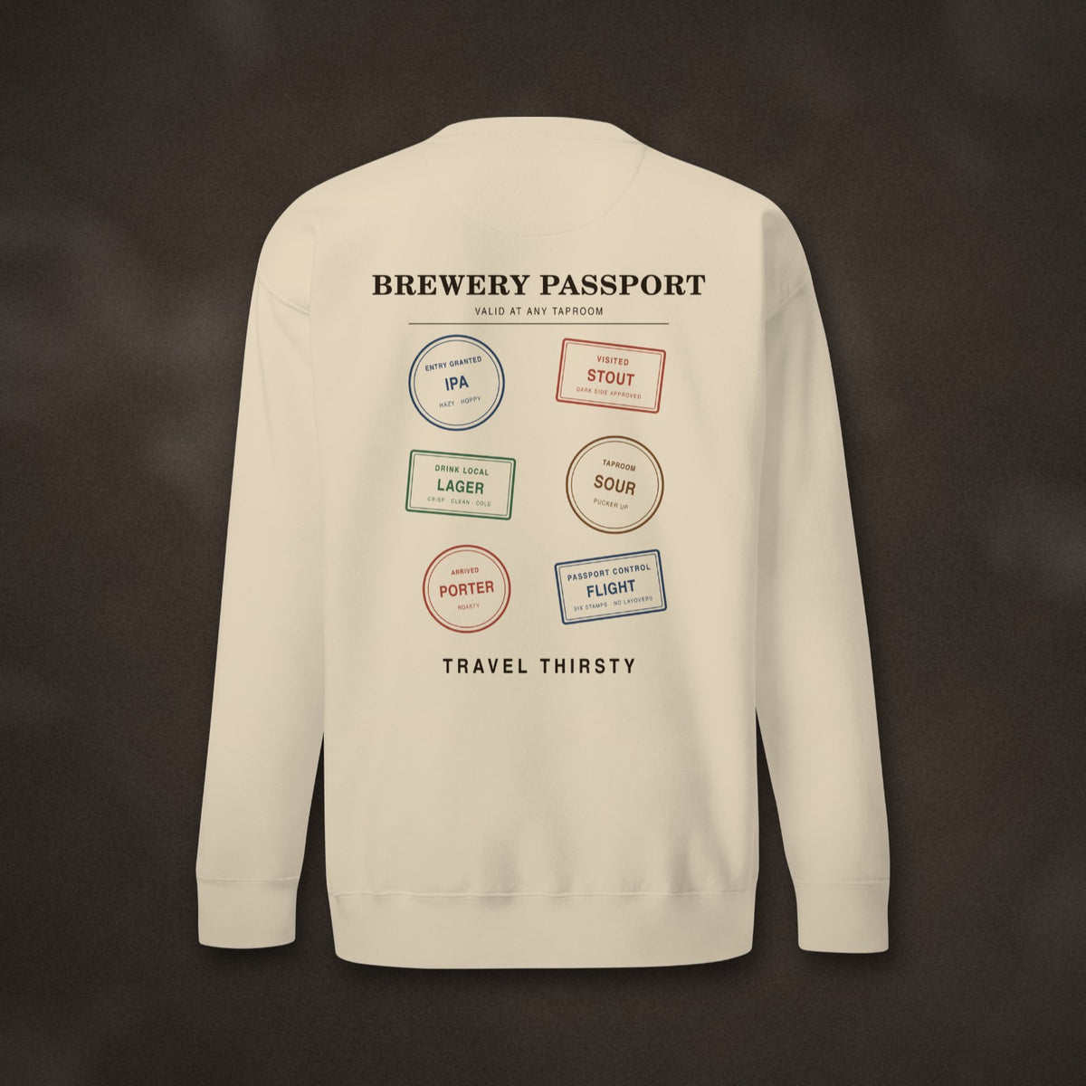 Back of the Brewery Passport Crewneck in Bone with brewery stamps and Travel Thirsty on dark slate