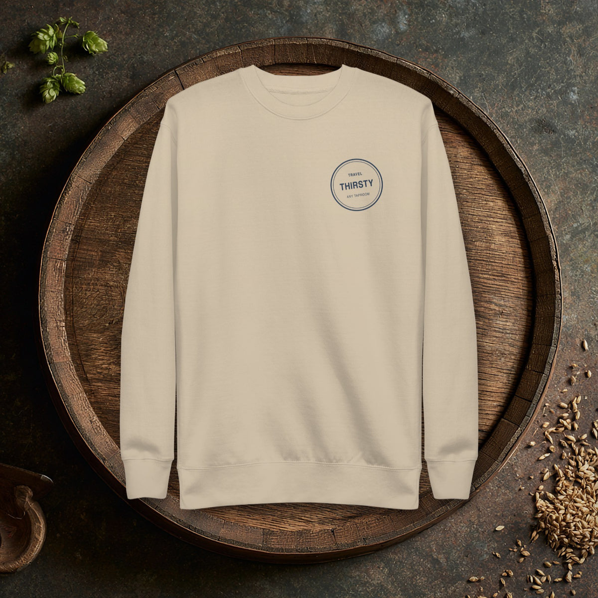 Brewery Passport Crewneck Sweatshirt in Bone laid flat on an oak barrel top