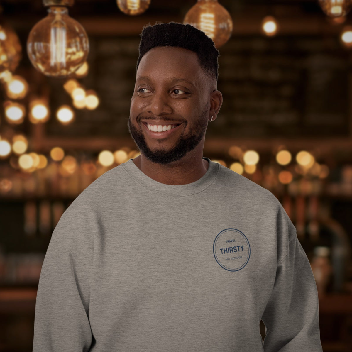 Man wearing the Brewery Passport Crewneck Sweatshirt in Carbon Grey in a taproom