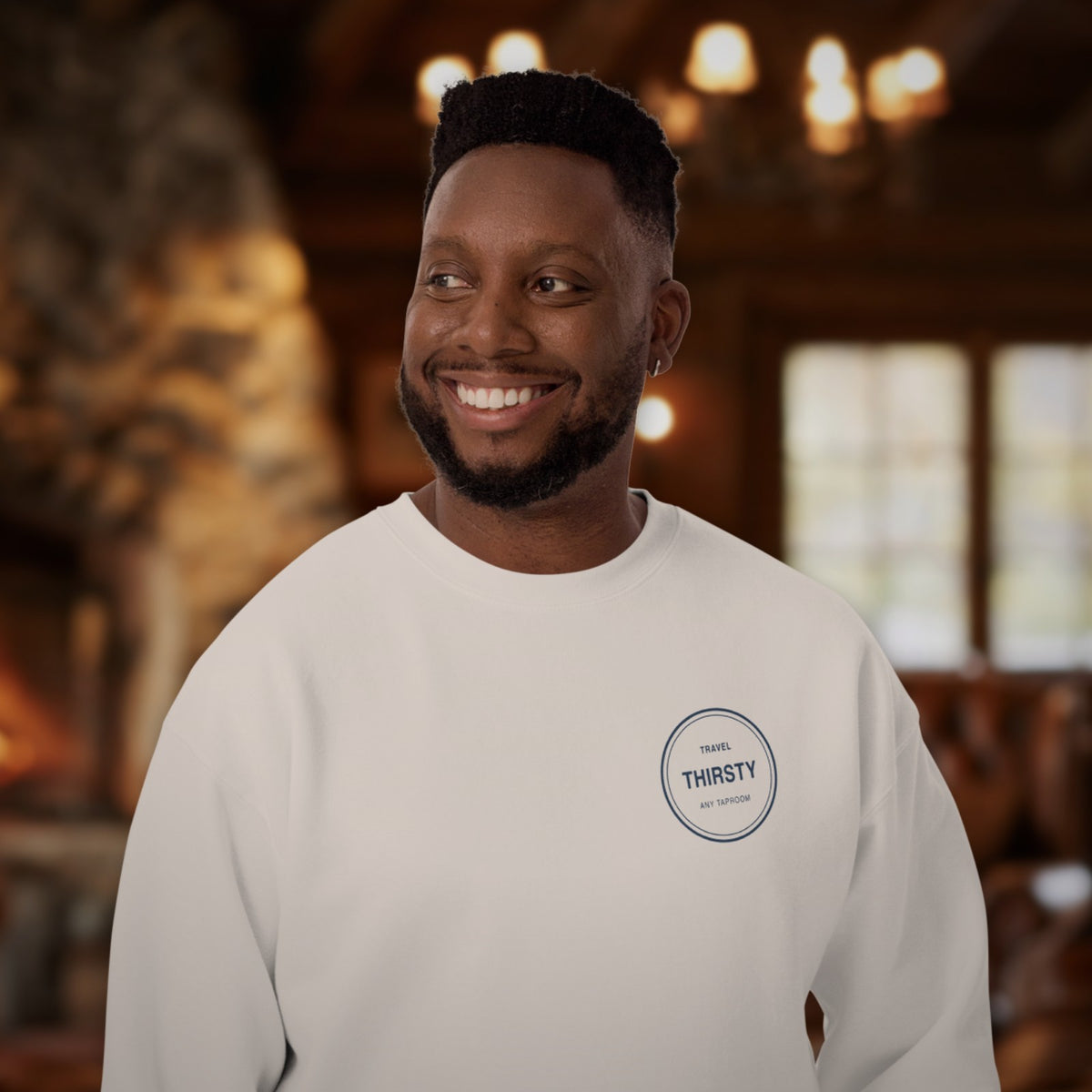 Man wearing the Brewery Passport Crewneck Sweatshirt in White in a cozy lodge