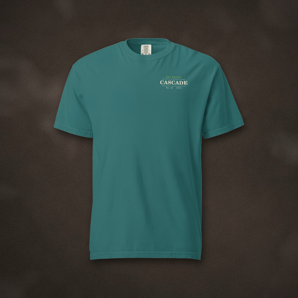 Hop Series Cascade T-Shirt in Emerald laid flat on dark slate