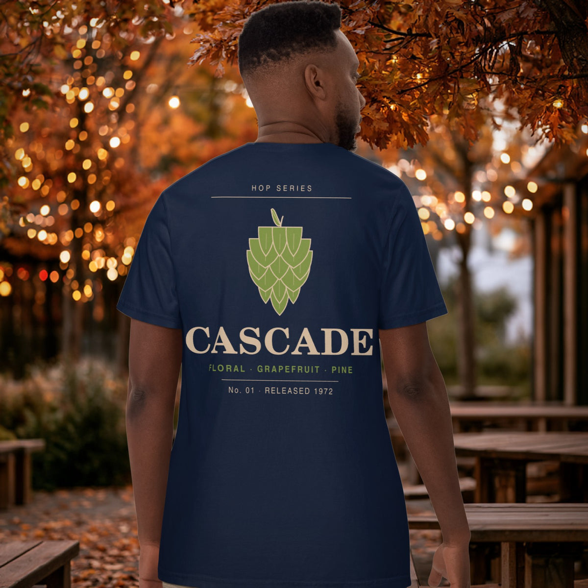 Man wearing the navy Hop Series Cascade T-Shirt walking through an autumn beer garden