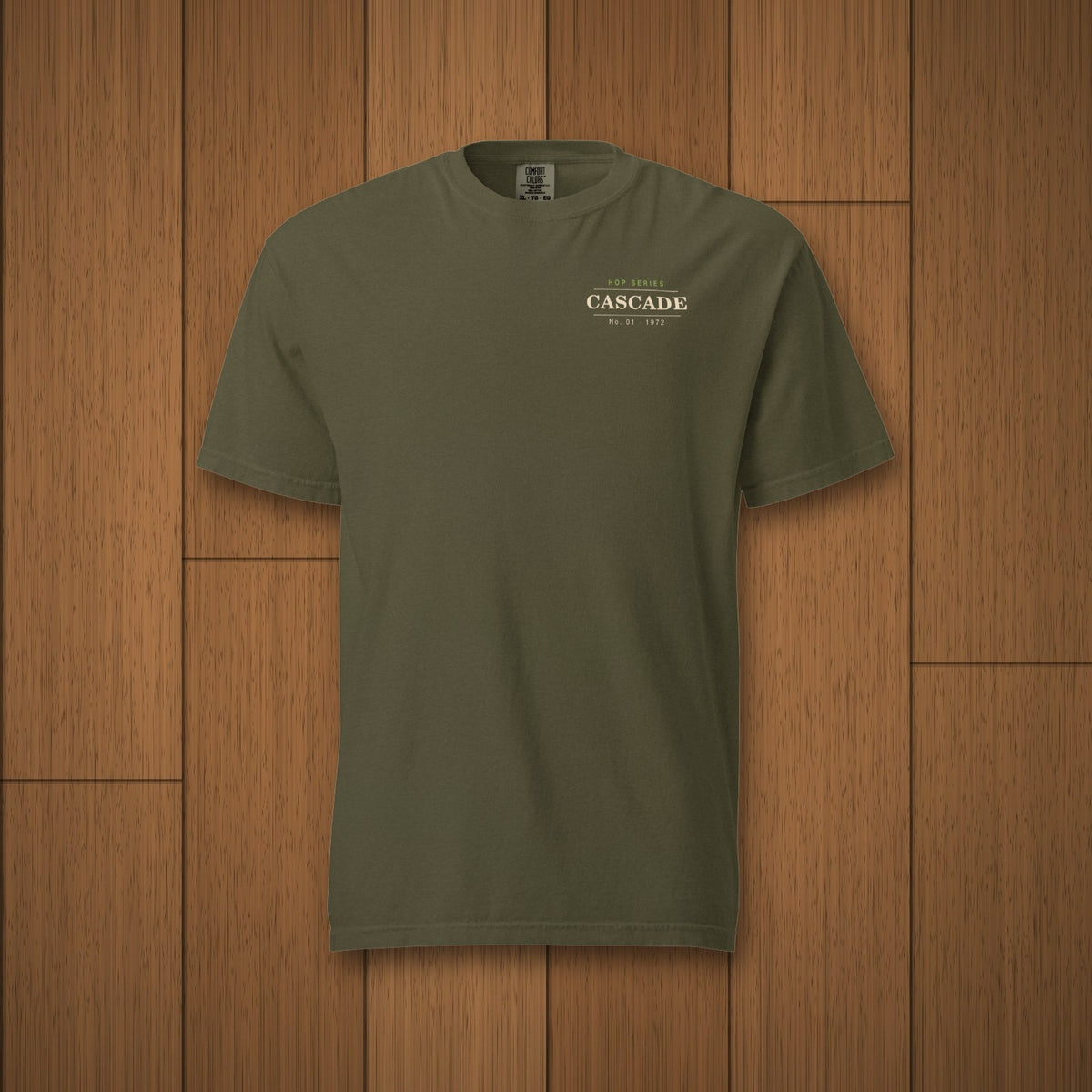 Hop Series Cascade T-Shirt in Sage laid flat on oak boards