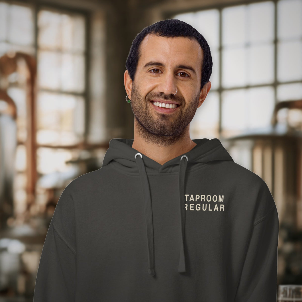Man wearing the Taproom Regular Hoodie in Vintage Black in a brewhouse