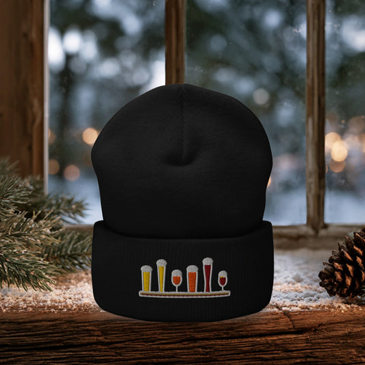 Winter Flight Embroidered Cuffed Beanie in Black on a snowy windowsill