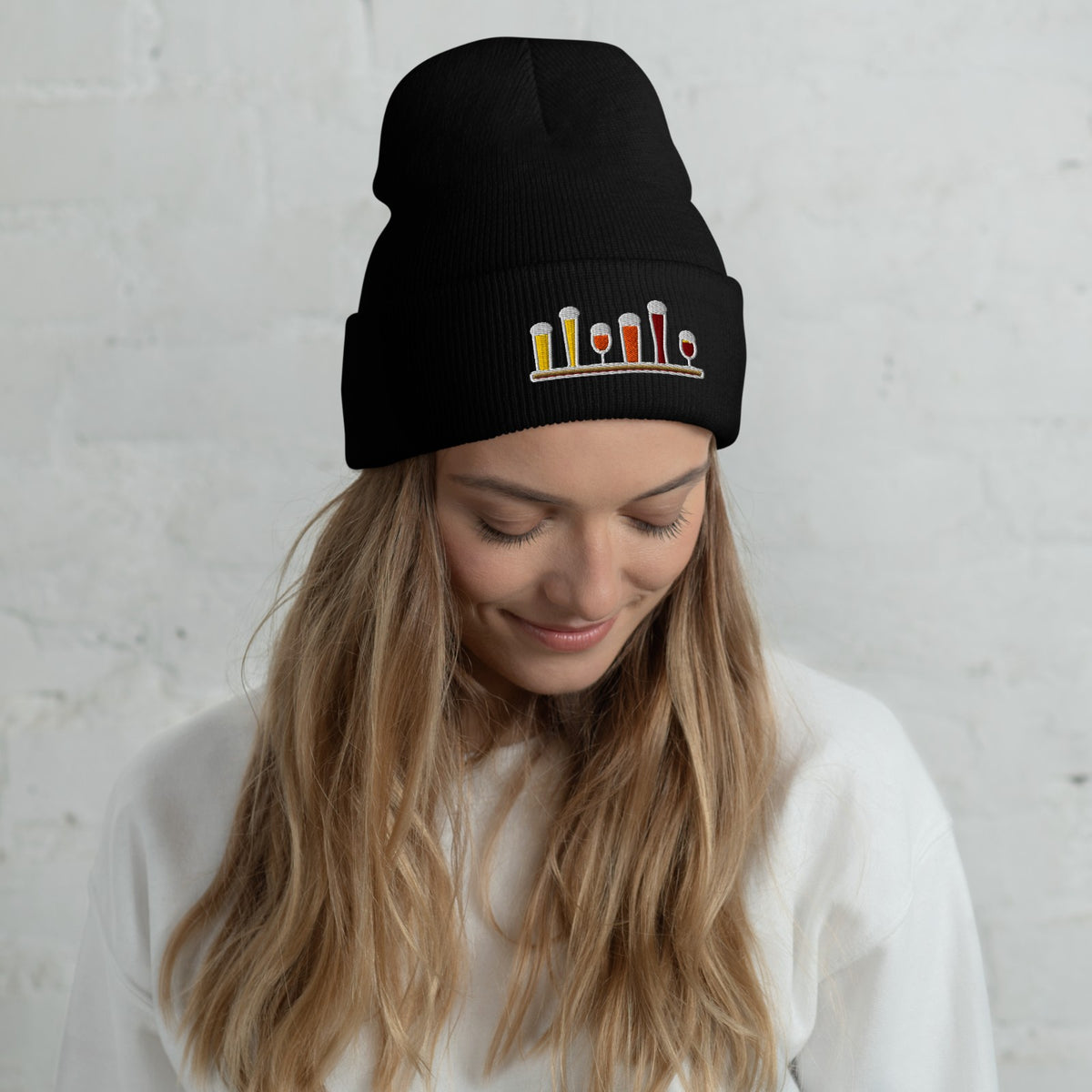 Woman wearing the Winter Flight Embroidered Cuffed Beanie in Black