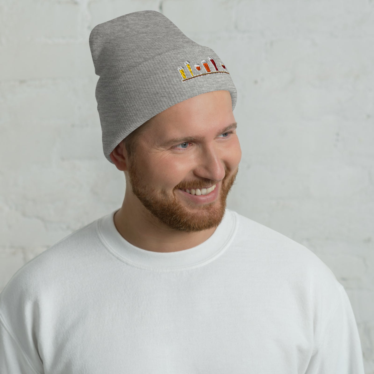 Man wearing the Winter Flight Embroidered Cuffed Beanie in Heather Grey