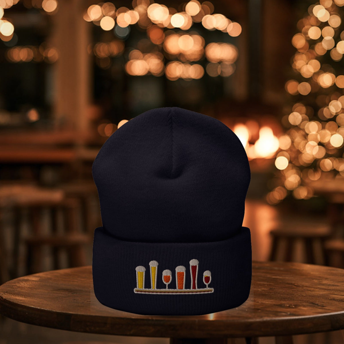 Winter Flight Embroidered Cuffed Beanie in Navy on a taproom table