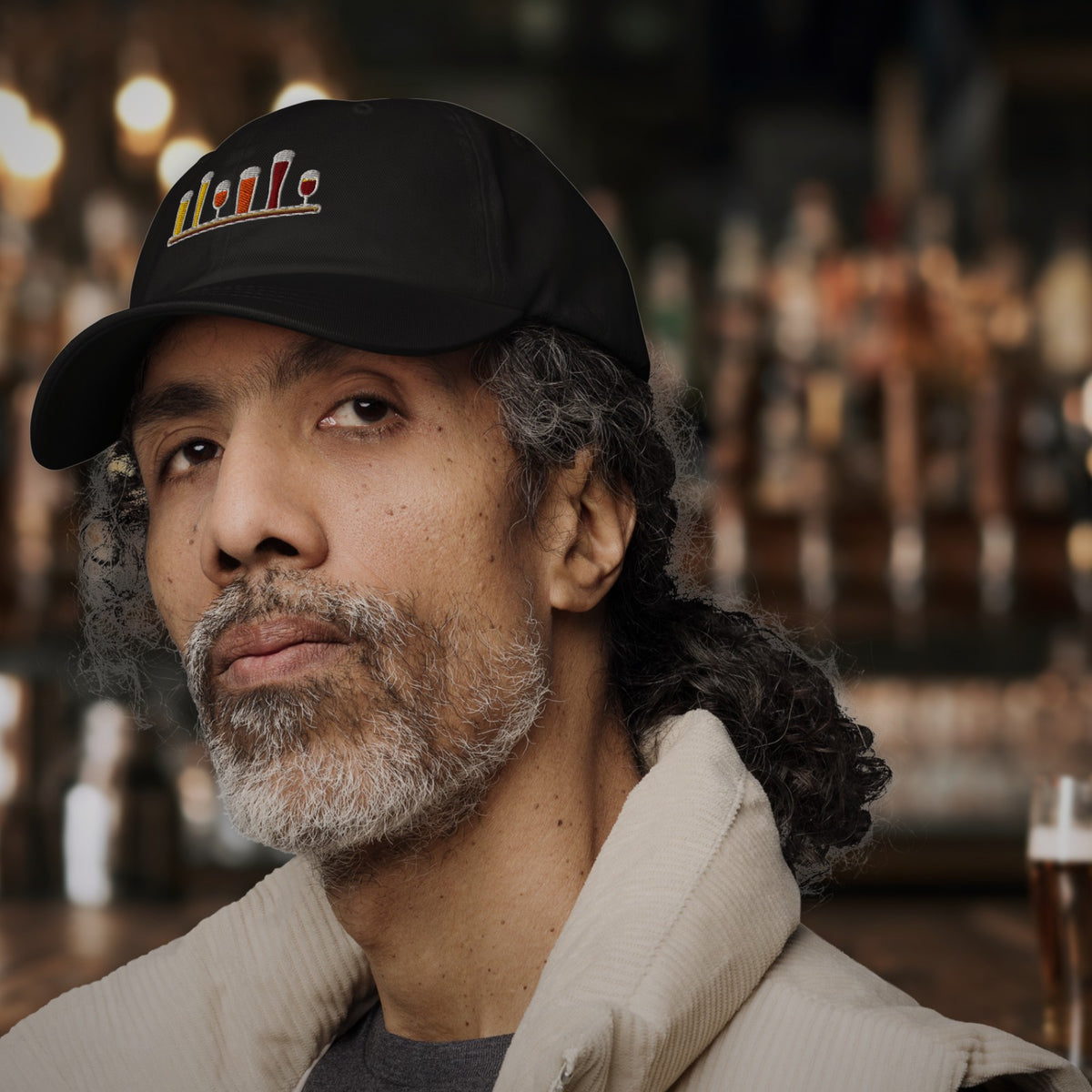 Man wearing the Winter Flight Embroidered Dad Hat in Black at the bar