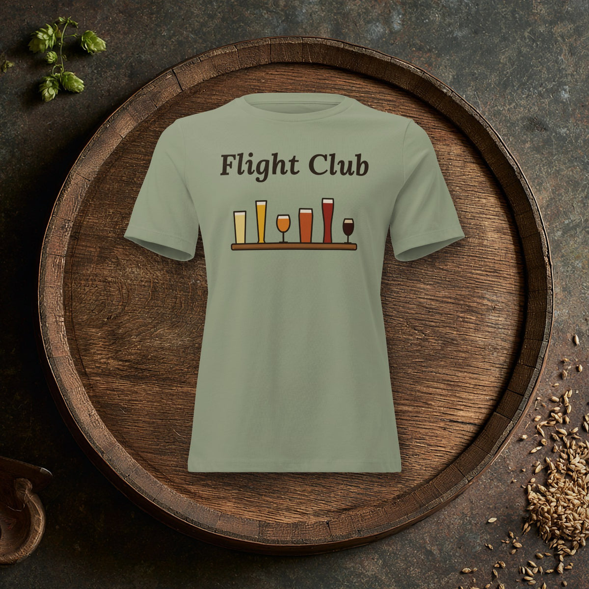 Women's Flight Club Relaxed T-Shirt in Sage laid flat on an oak barrel top